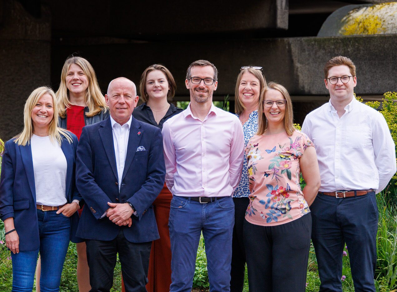 equantiis team members posing outside for a group photo