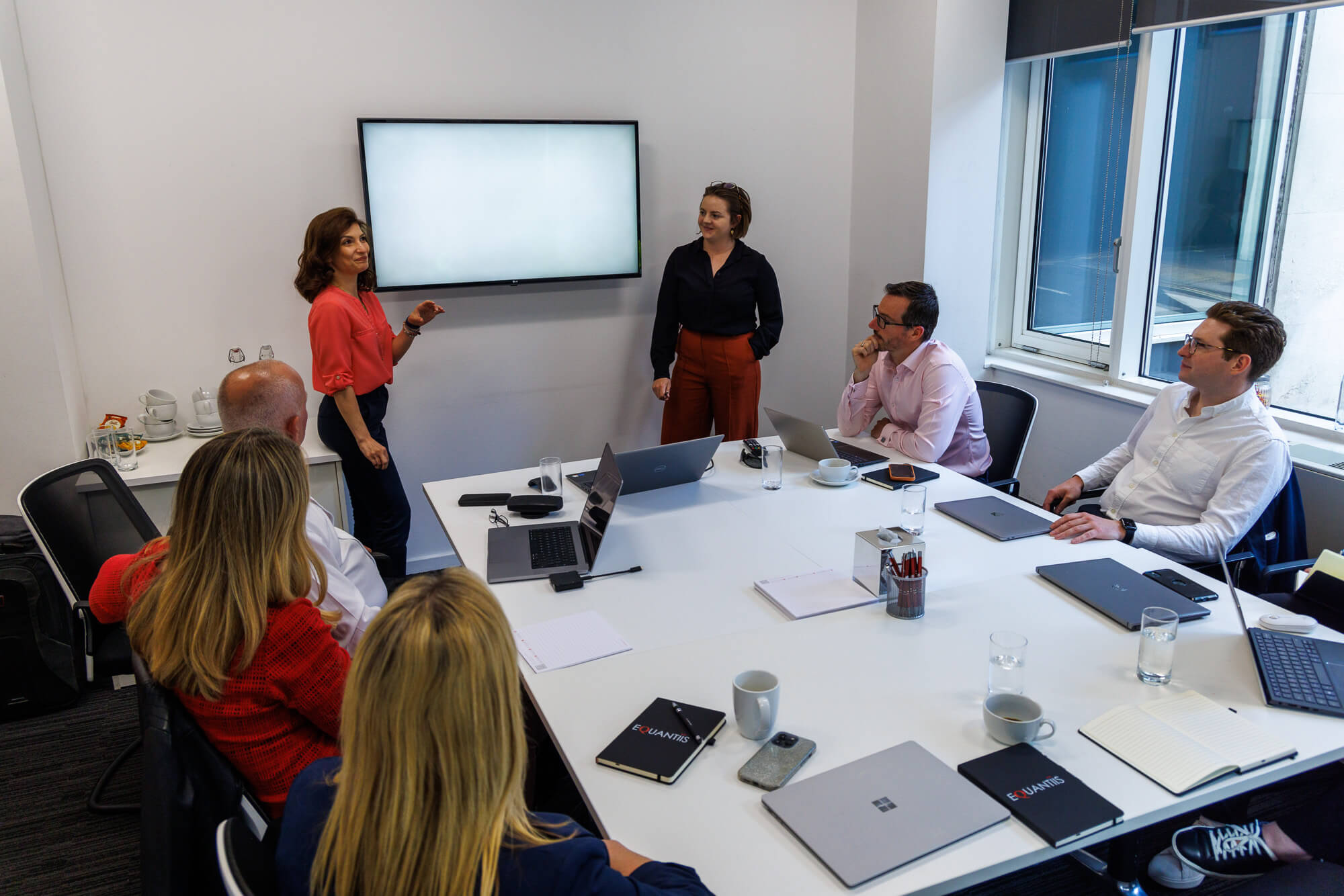 2 women are giving a presentation in the office