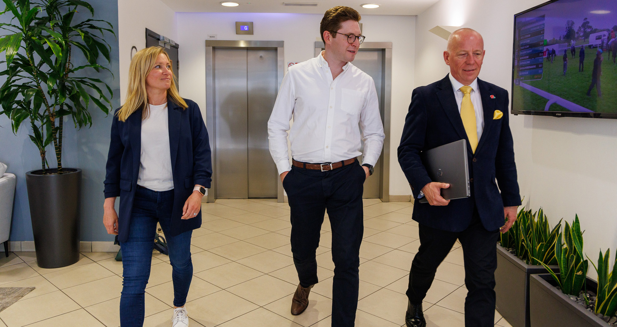 3 business people walking in a meeting